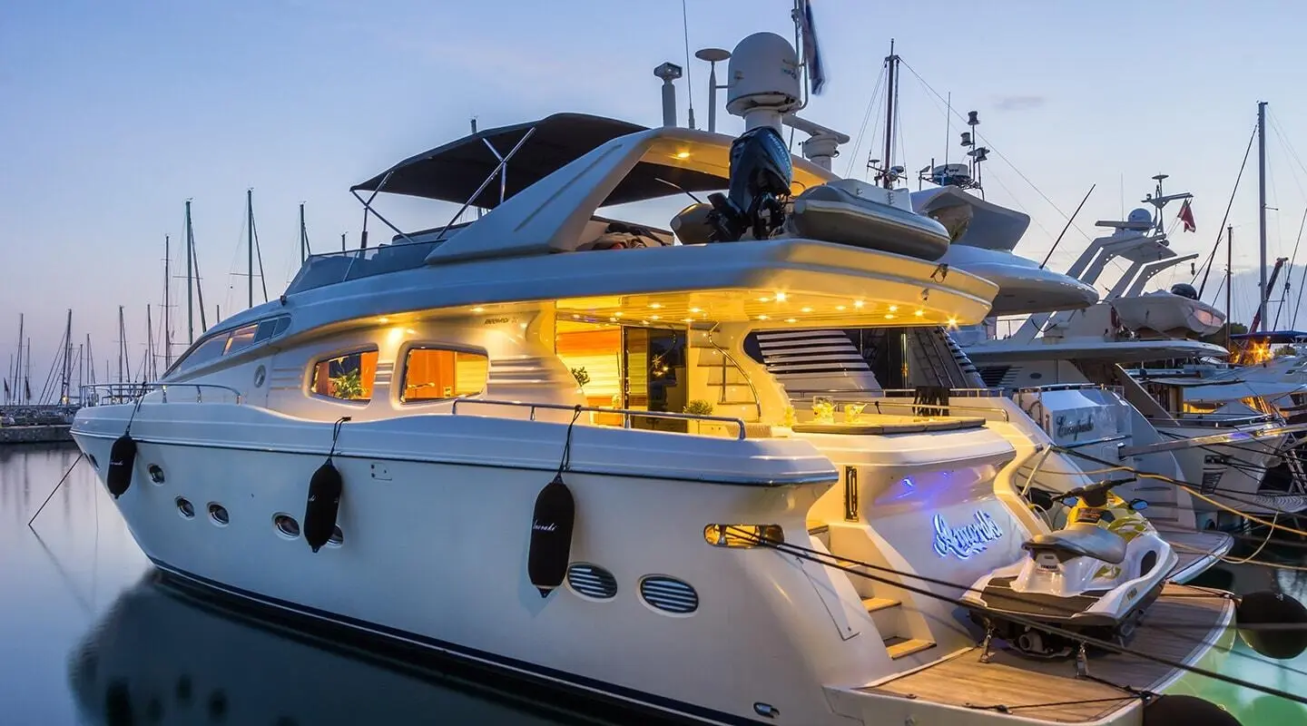 Yacht Amoraki docked in port, white motor yacht with upper deck and seating