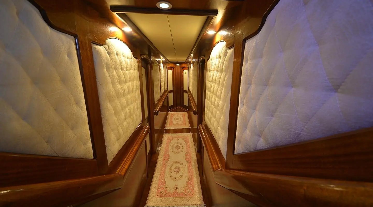 Prenses Bugce yacht interior hallway with warm lights and carpeted floor