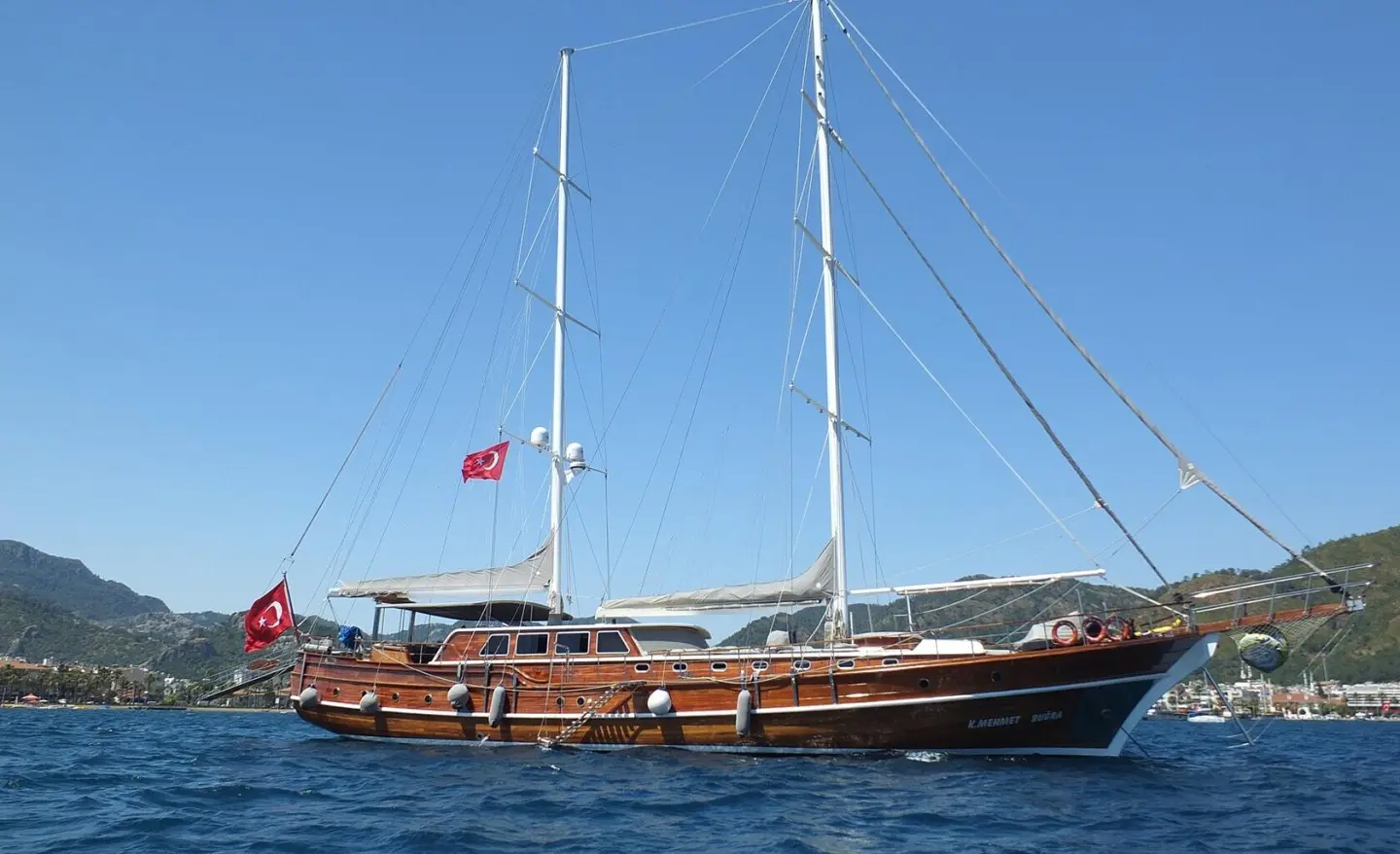 Kaptan Mehmet Bugra luxury gulet with dark hull and wooden deck sailing