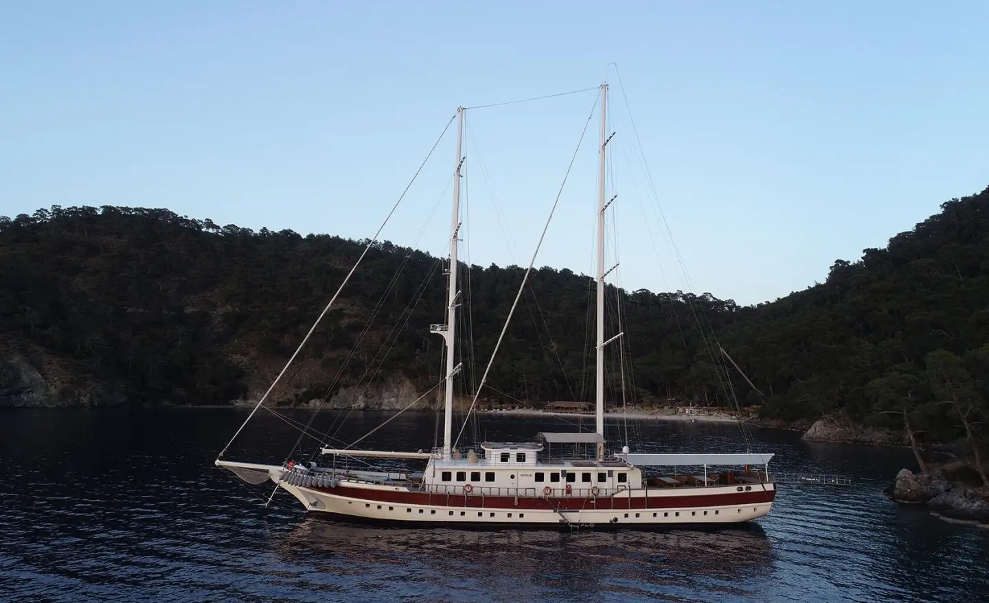 Luxury gulet named Tersane 8 anchored in calm blue sea at sunset