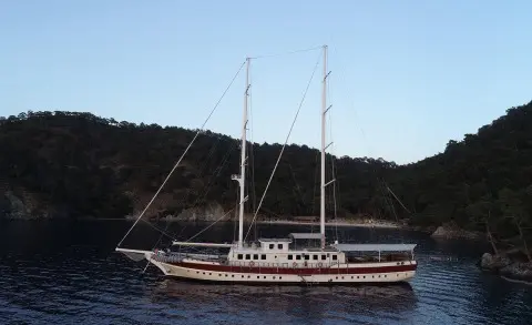 Luxury gulet named Tersane 8 anchored in calm blue sea at sunset