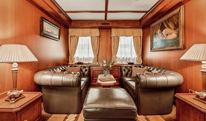 Seagull II cabin with a king bed, wood cabinetry, and porthole windows