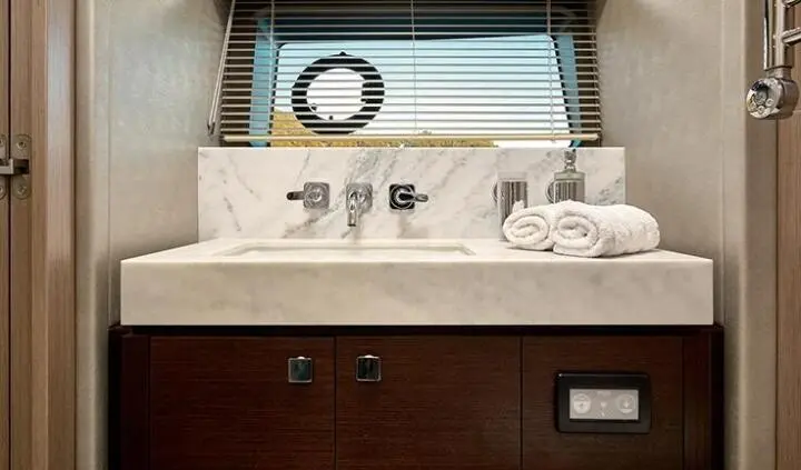 Master cabin with king bed, ensuite bathroom door visible on yacht Hideaway