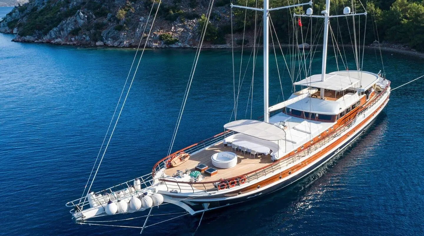Halcon Del Mar yacht anchored in clear blue water with sunlit deck gear
