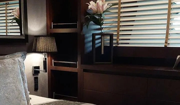Miraval yacht master cabin with king bed and ensuite bathroom, wood panels