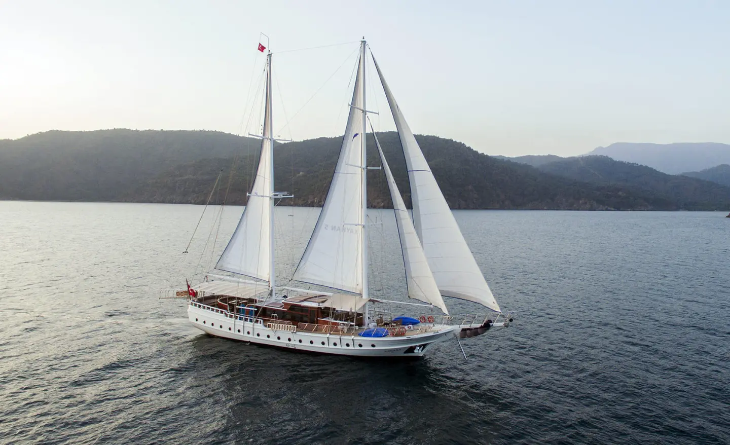 Gulet Kayhan 5 sailing yacht on calm blue water with billowing sails