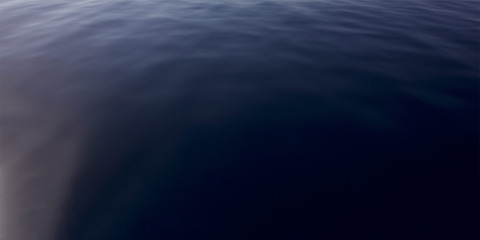 Dark blue sea surface with gentle ripples and subtle light reflections on open water