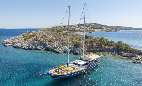 Gozdem The One gulet anchored in a rocky cove