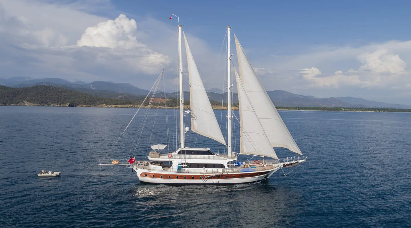 Kayhan 4 gulet sailing yacht on calm blue sea with sails up