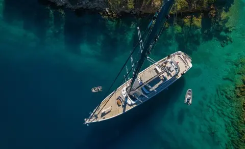 Aerial view of a gulet yacht named Long Island anchored in clear blue water