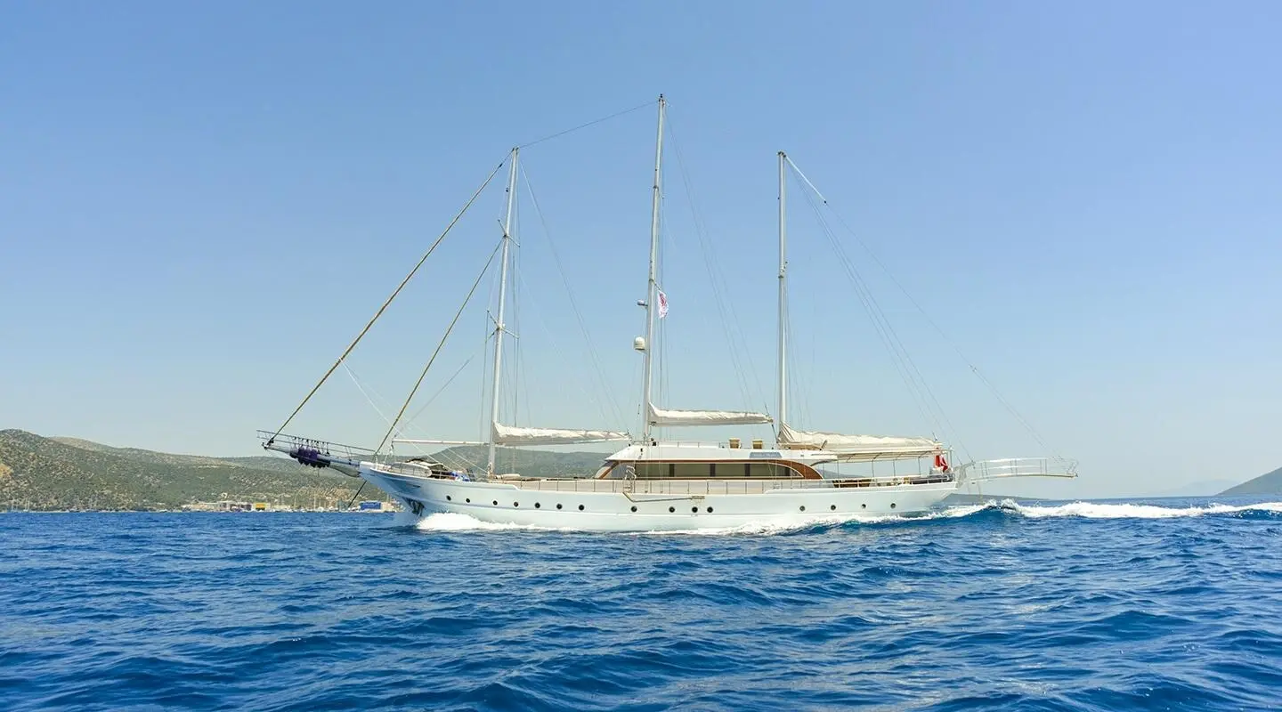 Three-masted luxury sailing yacht Bella Mare cruising on blue sea