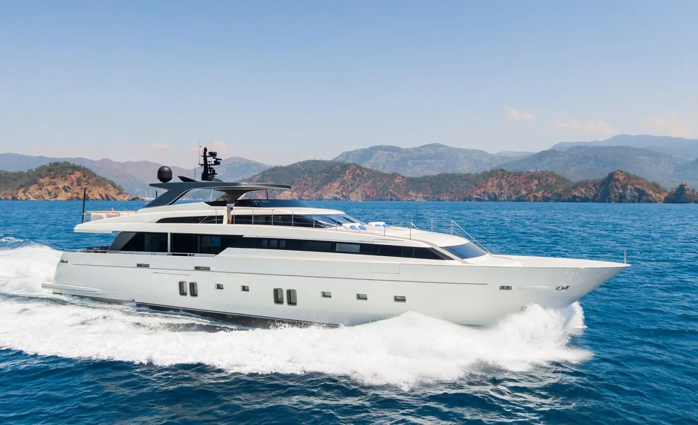 Morning Star luxury yacht cruising calm blue water with distant mountains