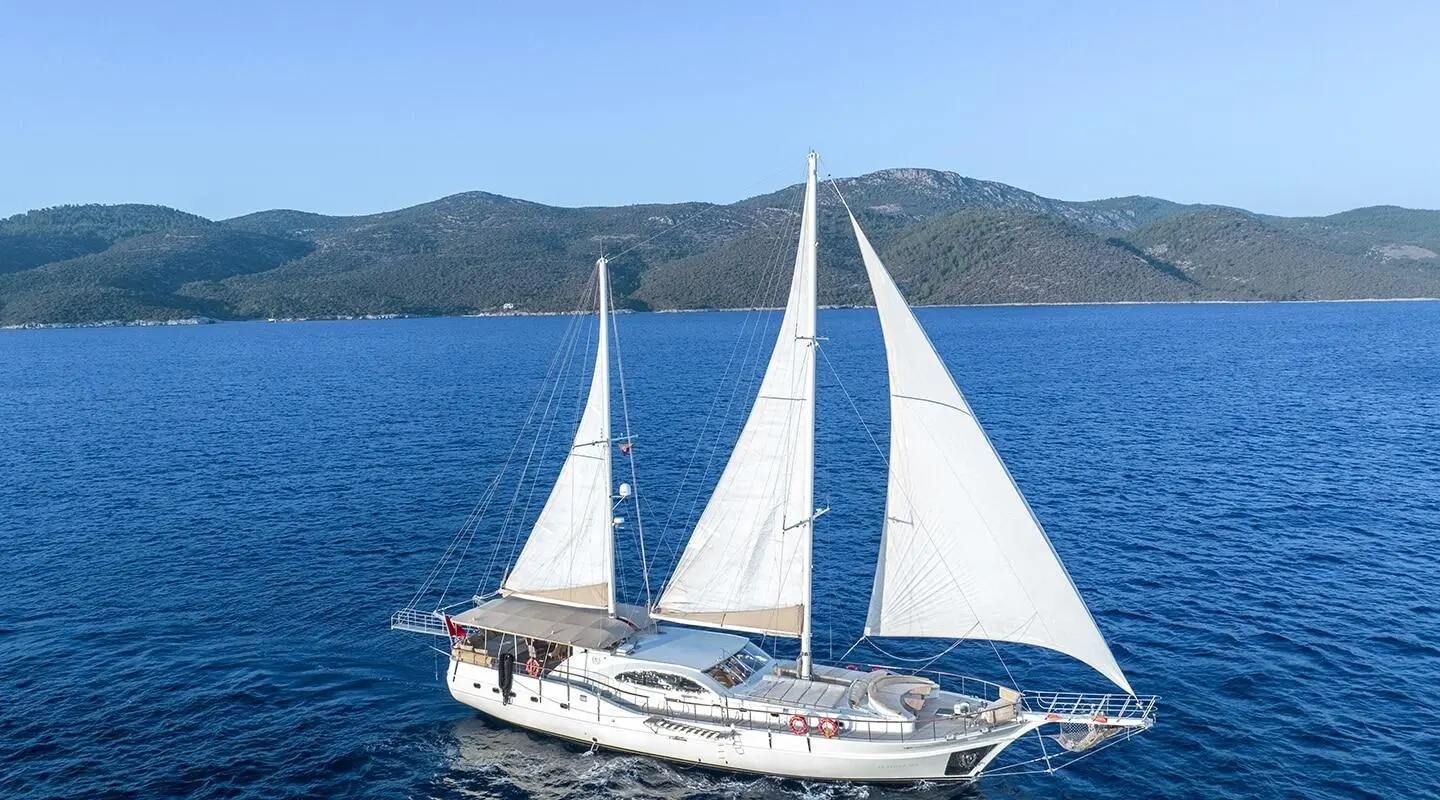 Queen Of Sea gulet sailing in blue sea with white sails fully unfurled