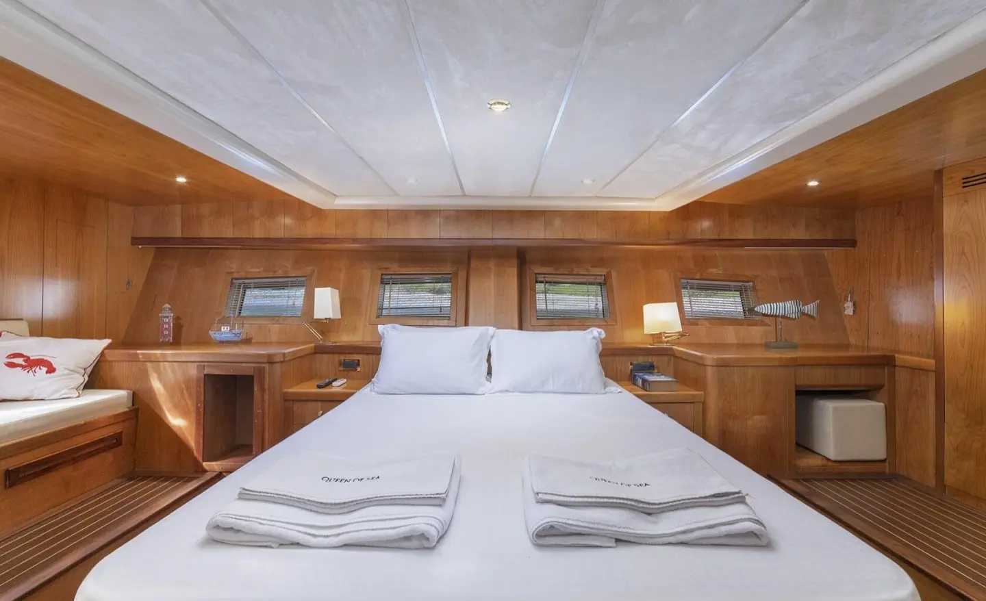 Interior of a luxury yacht galley dining area with neatly set table and wood paneling