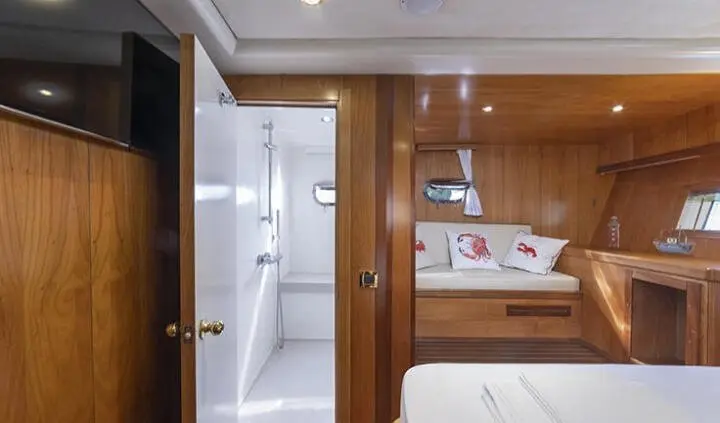 Queen Of Sea master cabin with king bed and en-suite bathroom, wooden panels