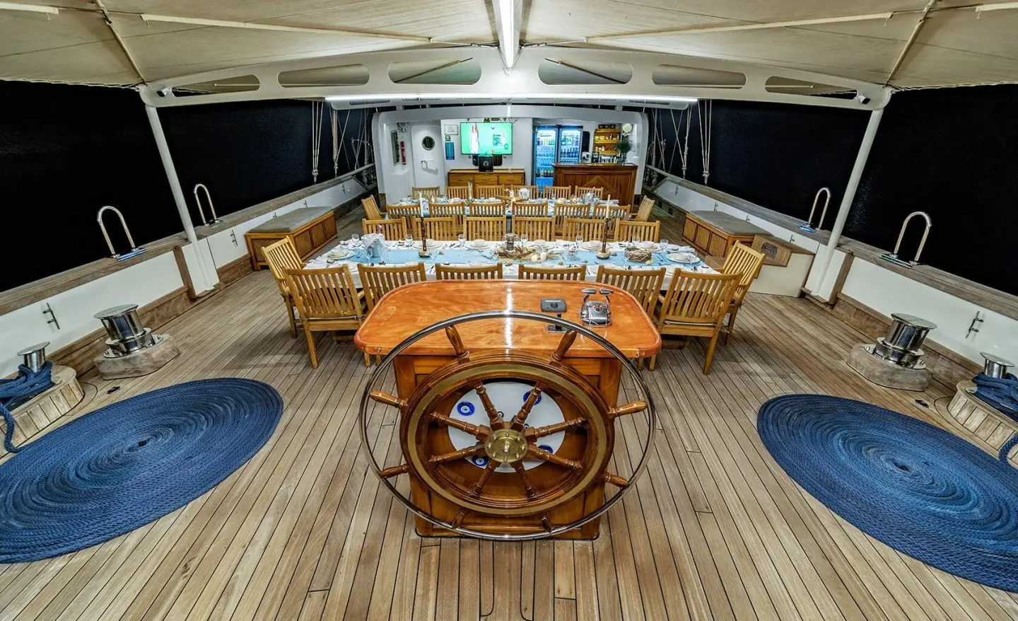 Tersane 8 yacht deck scene with steering wheel, seating, and sunset-lit horizon