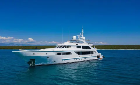 Luxury yacht Alalya anchored in calm blue water with clear sky