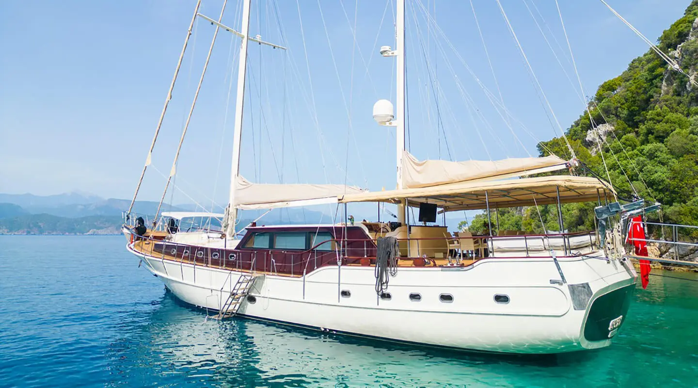 Luxurious gulet yacht anchored with deck shade and seating on the stern