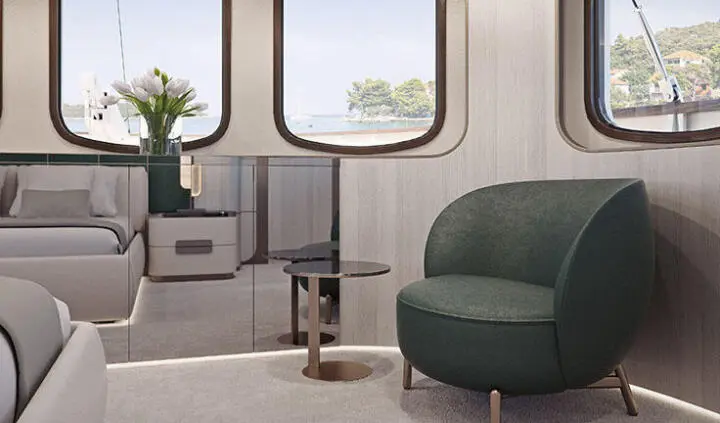 Master cabin with king bed, ensuite, round window view, Maia yacht interior