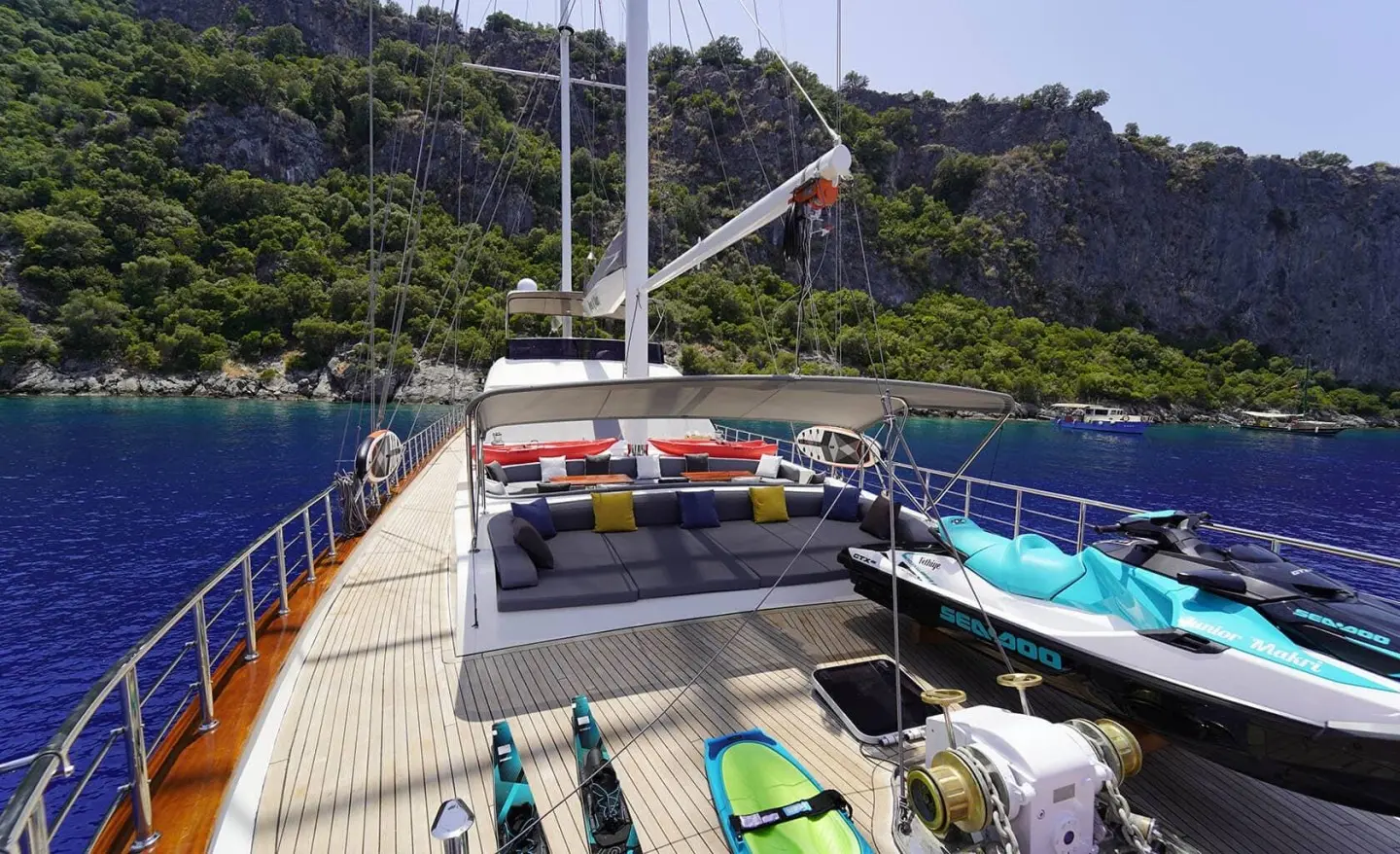 Queen Of Makri yacht docked at sunset with colorful inflatable toys on deck