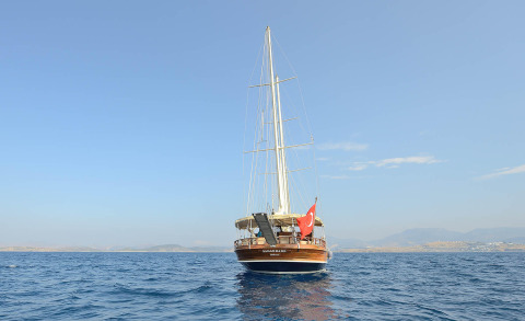 Samarkand gulet sailing on the sea, wooden hull with tall mast and Turkish flag