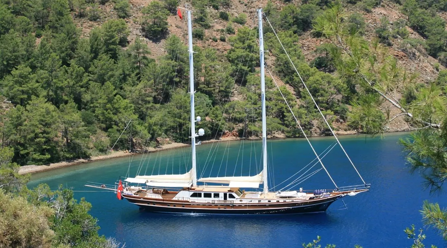 gulet Kaya Guneri 5 anchored in a calm cove with a wooden hull and two masts