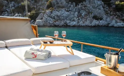 Derin Deniz yacht moored at sunset with deck seating and calm turquoise sea