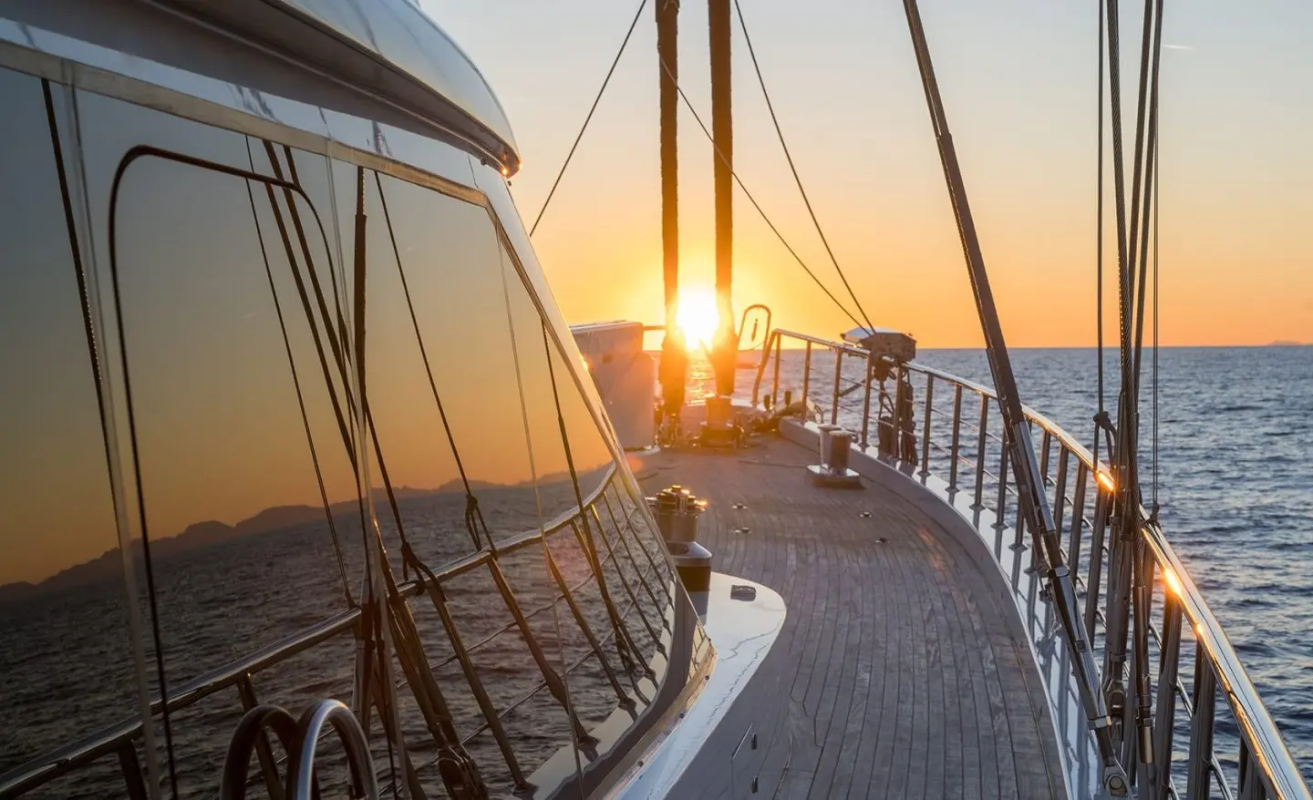 Sunlit yacht deck on a luxury gulet at sunset, Ocean horizon ahead
