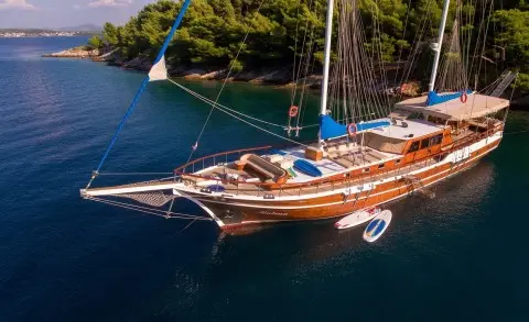 Malena luxury gulet cruising at sunset with calm blue sea and deck loungers