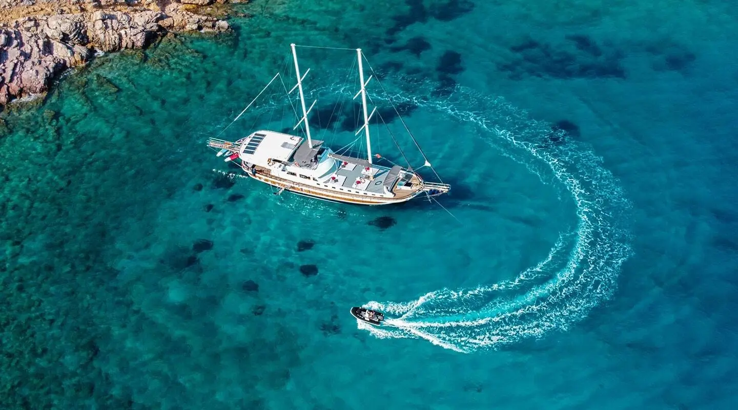 Bodrum Queen luxury gulet anchored in clear turquoise sea at sunset