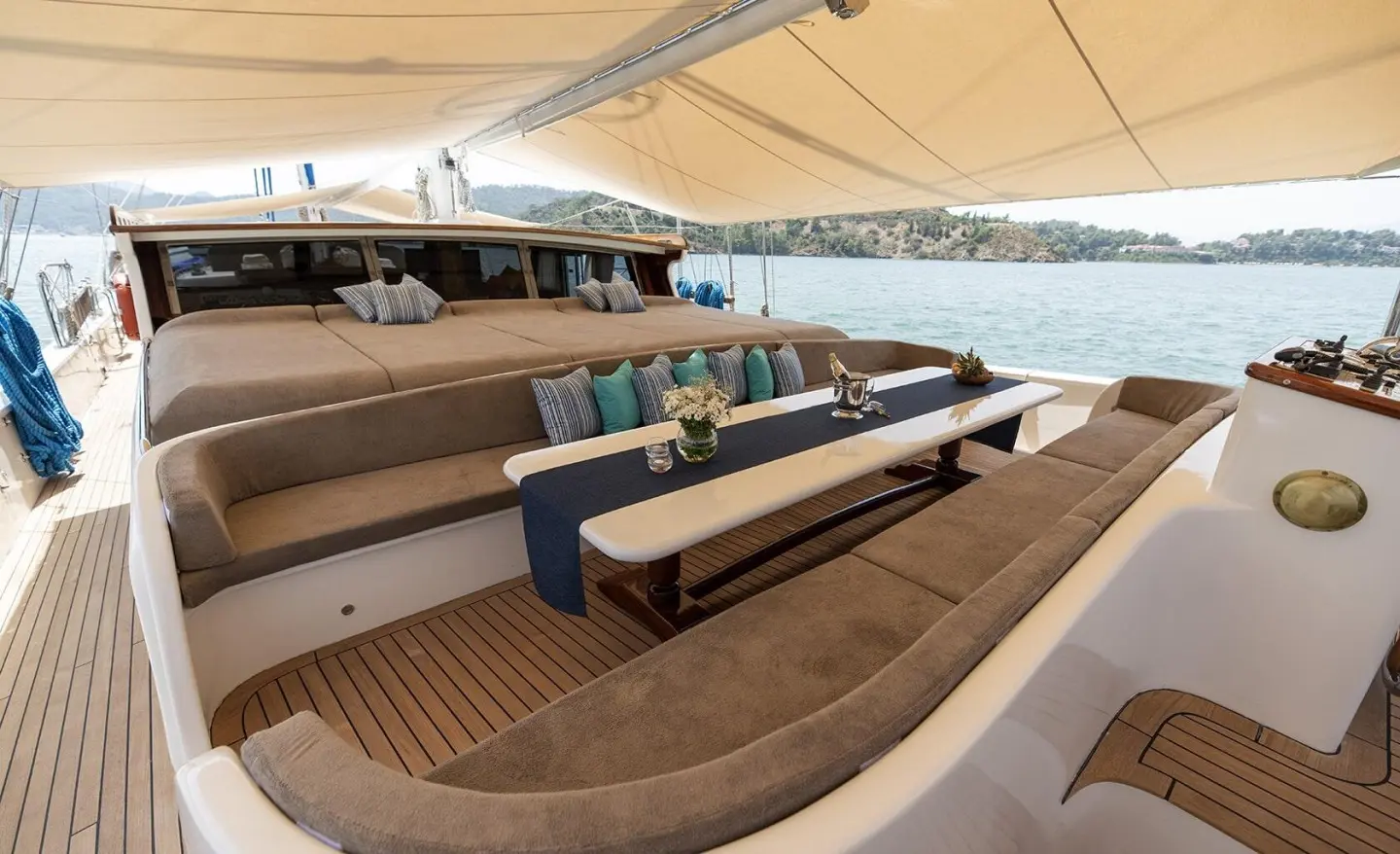 Kayhan Kaptan yacht on a calm sunset with seating and shaded deck