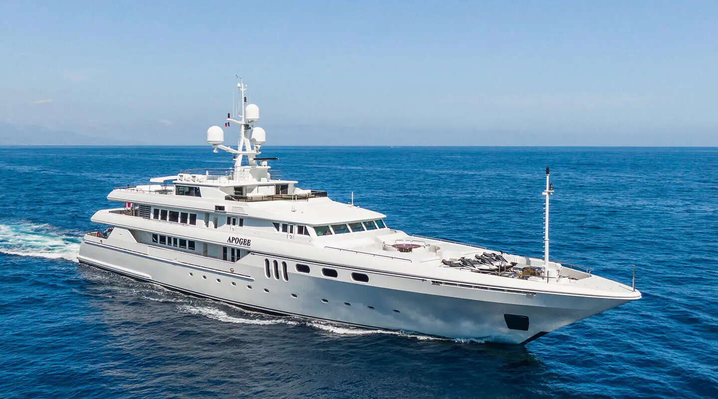 Luxury Apogee yacht anchored in blue sea with multiple decks and pool