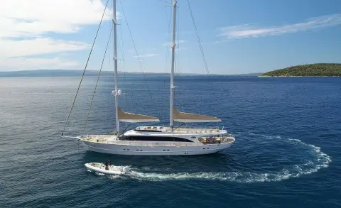 Ayring sailing yacht Acapella with white hull on calm blue sea under clear sky