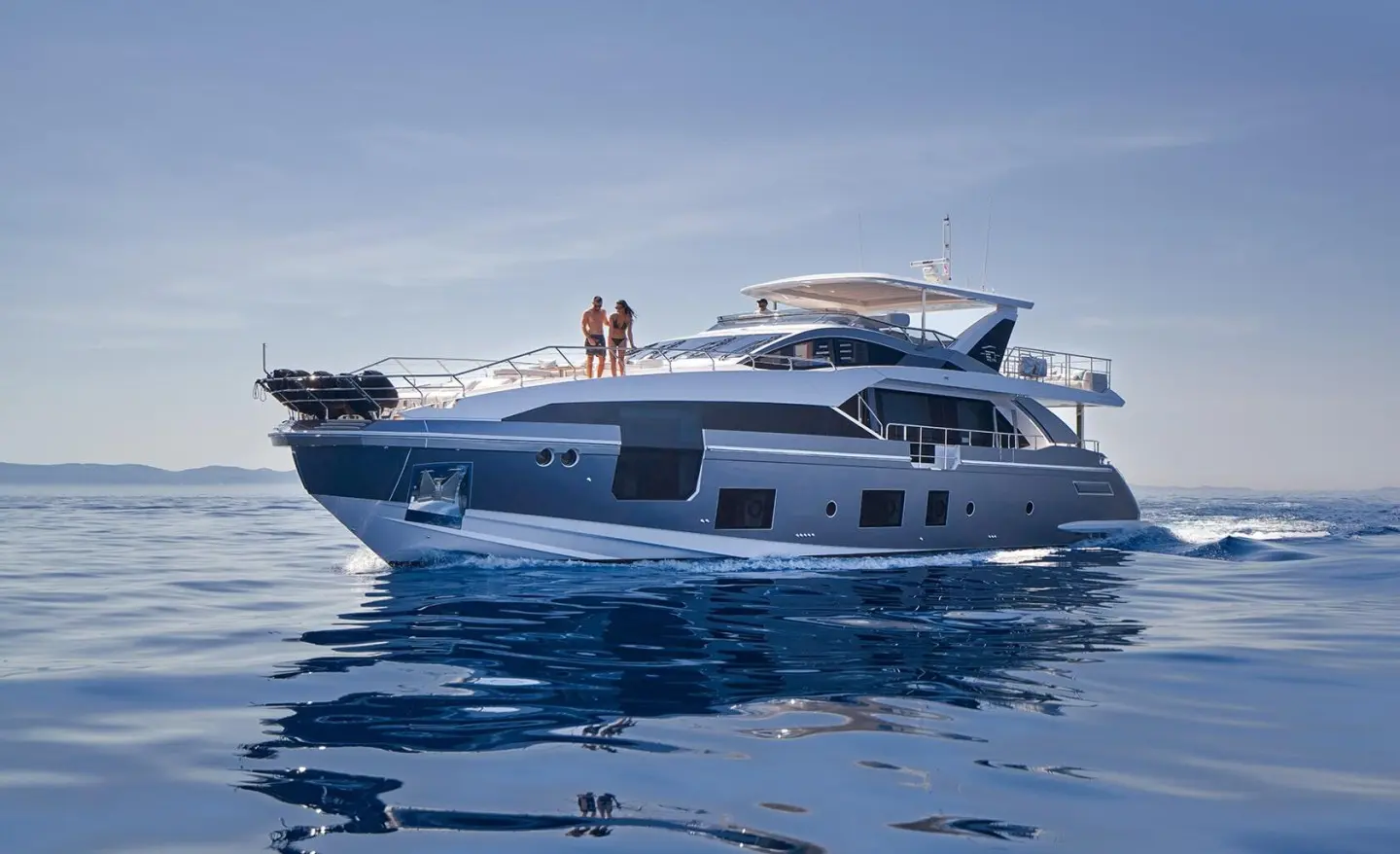 Aluminia Too yacht anchored on calm blue water with clear sky backdrop