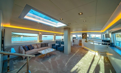 Interior of a luxury yacht lounge with windows and sea view