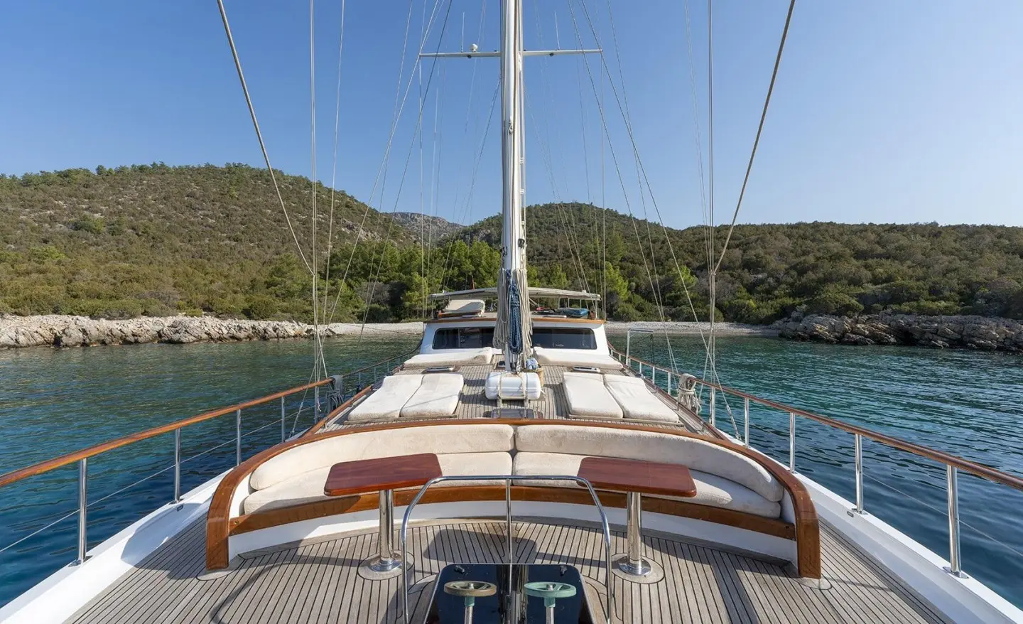 Artemis yacht deck view at sunset, ropes, sails and turquoise sea