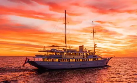 Bellezza luxury sailing yacht at sunset with sails down and calm sea