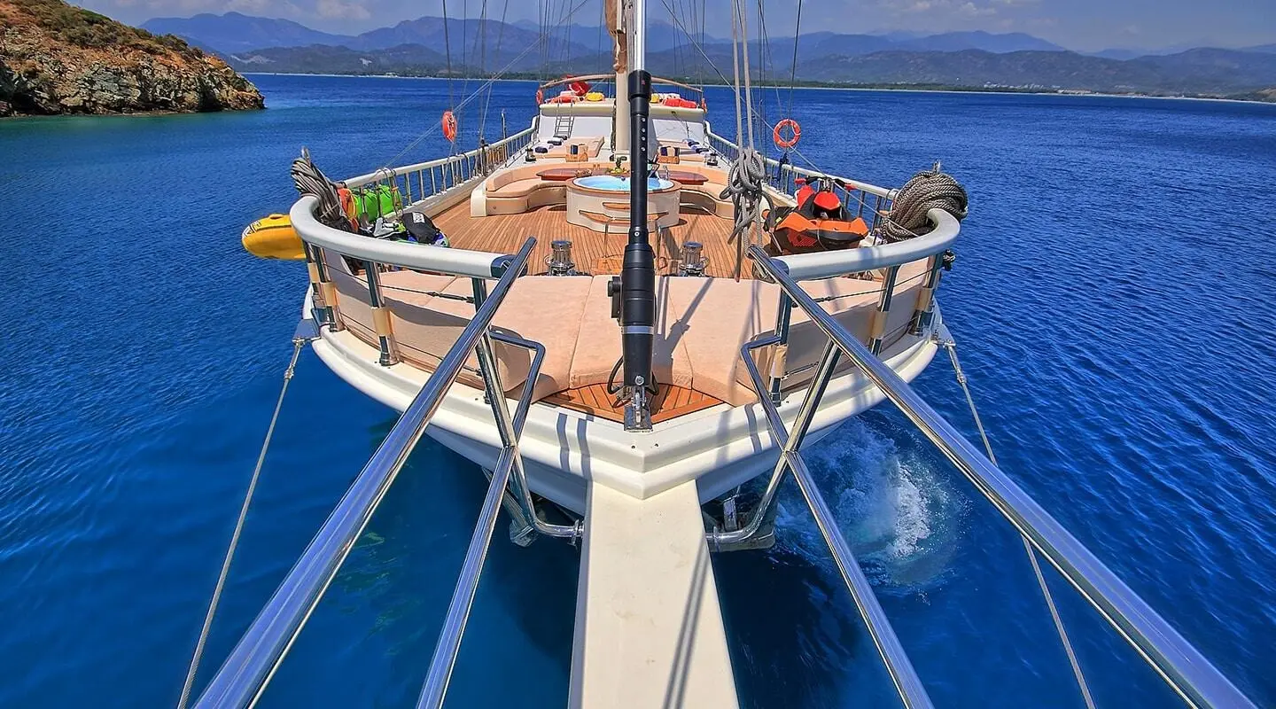 Bow of Queen Of Salmakis yacht at sunset with blue sea around