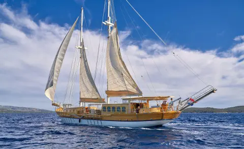 Libra luxury gulet sailing at sunset with white sails on blue sea