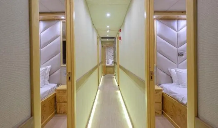 Interior cabin of Belgin Sultan yacht with bunk beds and a narrow corridor