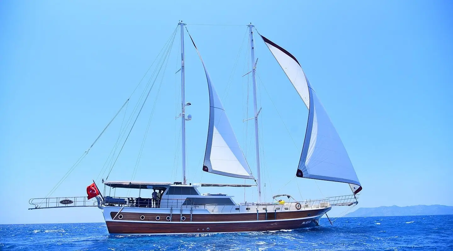 Maya luxury gulet sailing at sunset with blue sky and calm sea