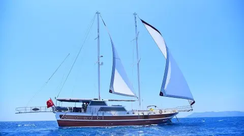 Maya luxury gulet sailing at sunset with blue sky and calm sea