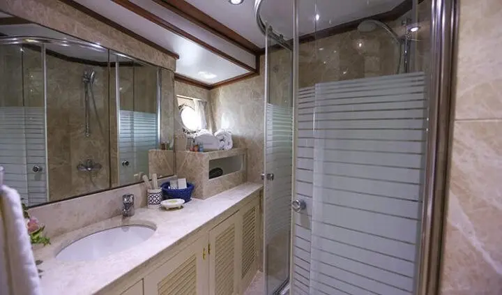 Guest cabin bath on Gazella yacht, sink and mirror visible