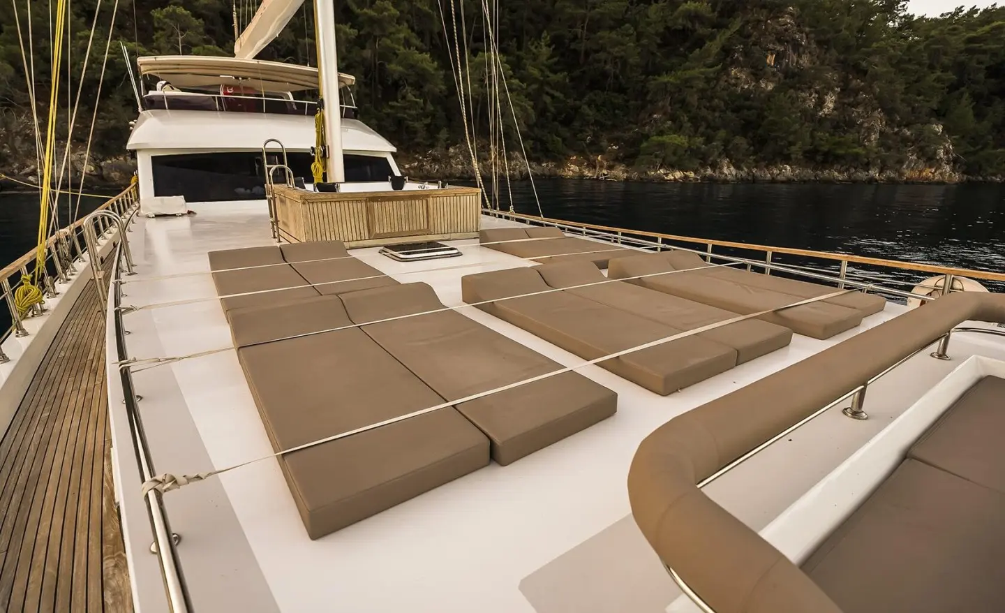 Belgin Sultan gulet sun deck with cushioned lounge seating and railing view