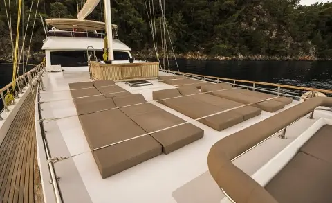 Belgin Sultan gulet sun deck with cushioned lounge seating and railing view
