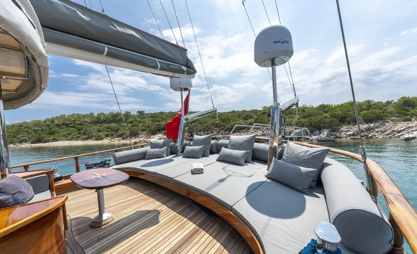 On deck of a luxury gulet at sunset with wooden deck and seating areas