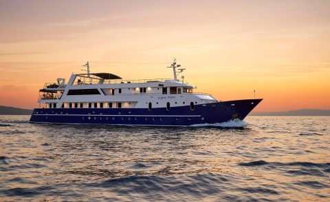 Lupus Mare luxury yacht cruising at sunset with blue hull and white superstructure