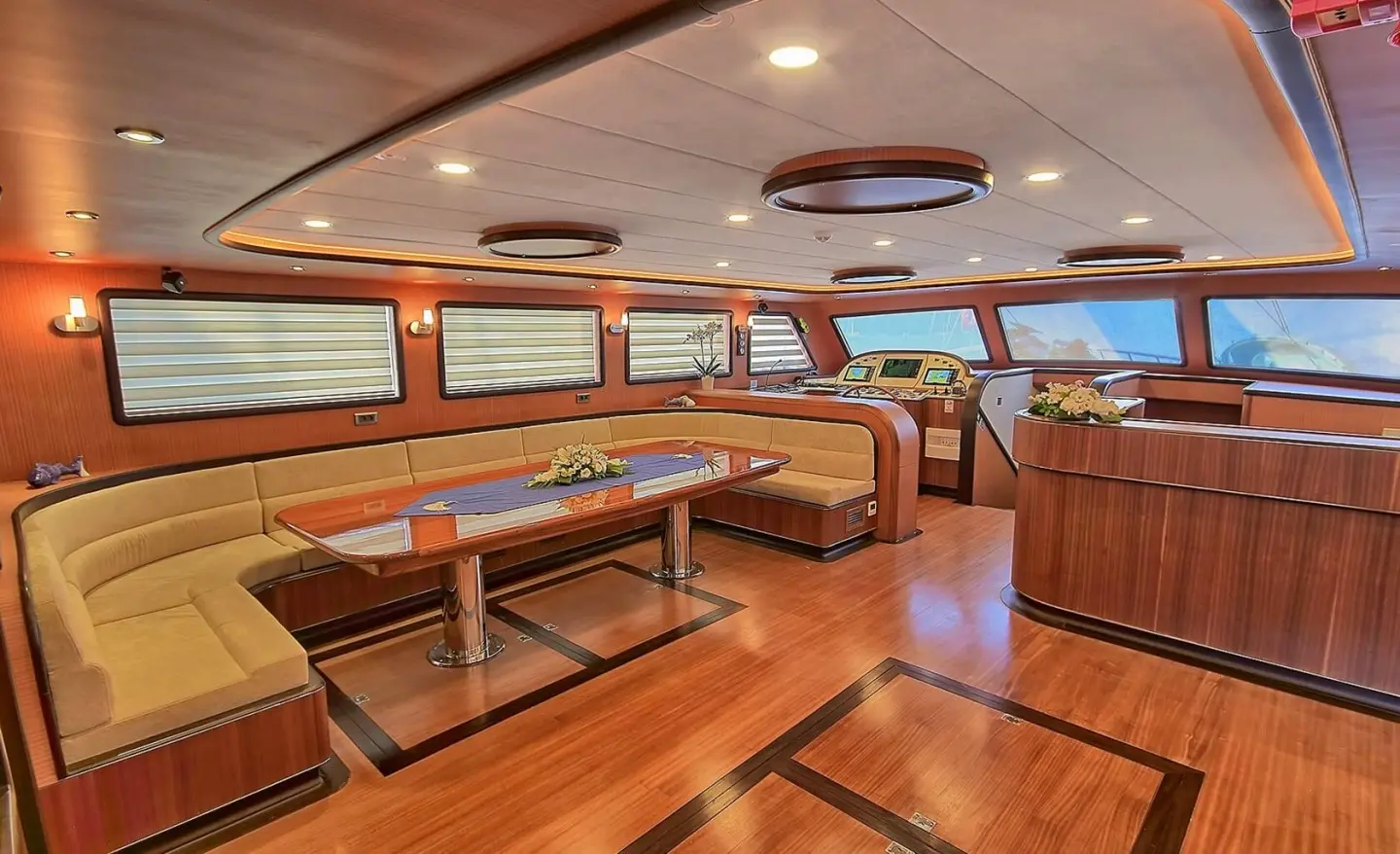 Interior of Queen Of Salmakis gulet with wooden benches and teak deck