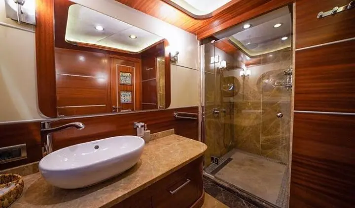 La Bella Vita master cabin ensuite bathroom with wooden cabinetry and glass shower
