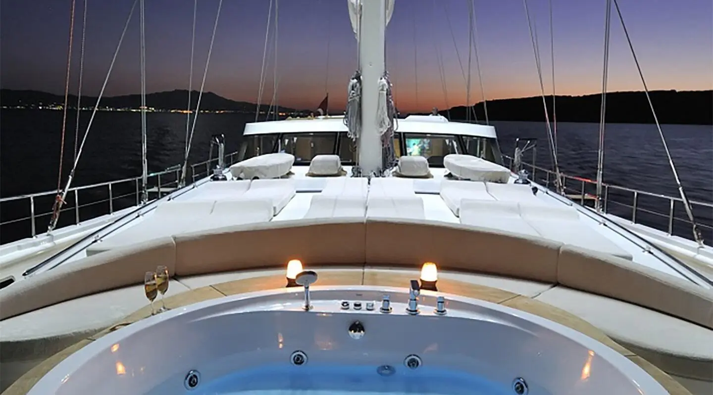 Dolce Mare yacht bow view from deck, sunlit white hulls and blue water